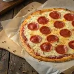 Cottage cheese pizza crust topped with melted cheese and turkey pepperoni